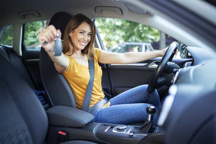 beautiful-female-women-driver-sitting-in-her-vehicle-and-holding-car-keys-ready-for-drive-min