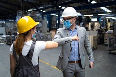 factory-manager-and-worker-greeting-each-other-with-elbow-bump-due-to-global-corona-virus-pandemic-and-danger-of-infection-min